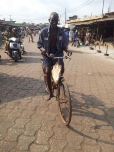 Uncycliste âgé dans les rues de Porto Novo, Bénin